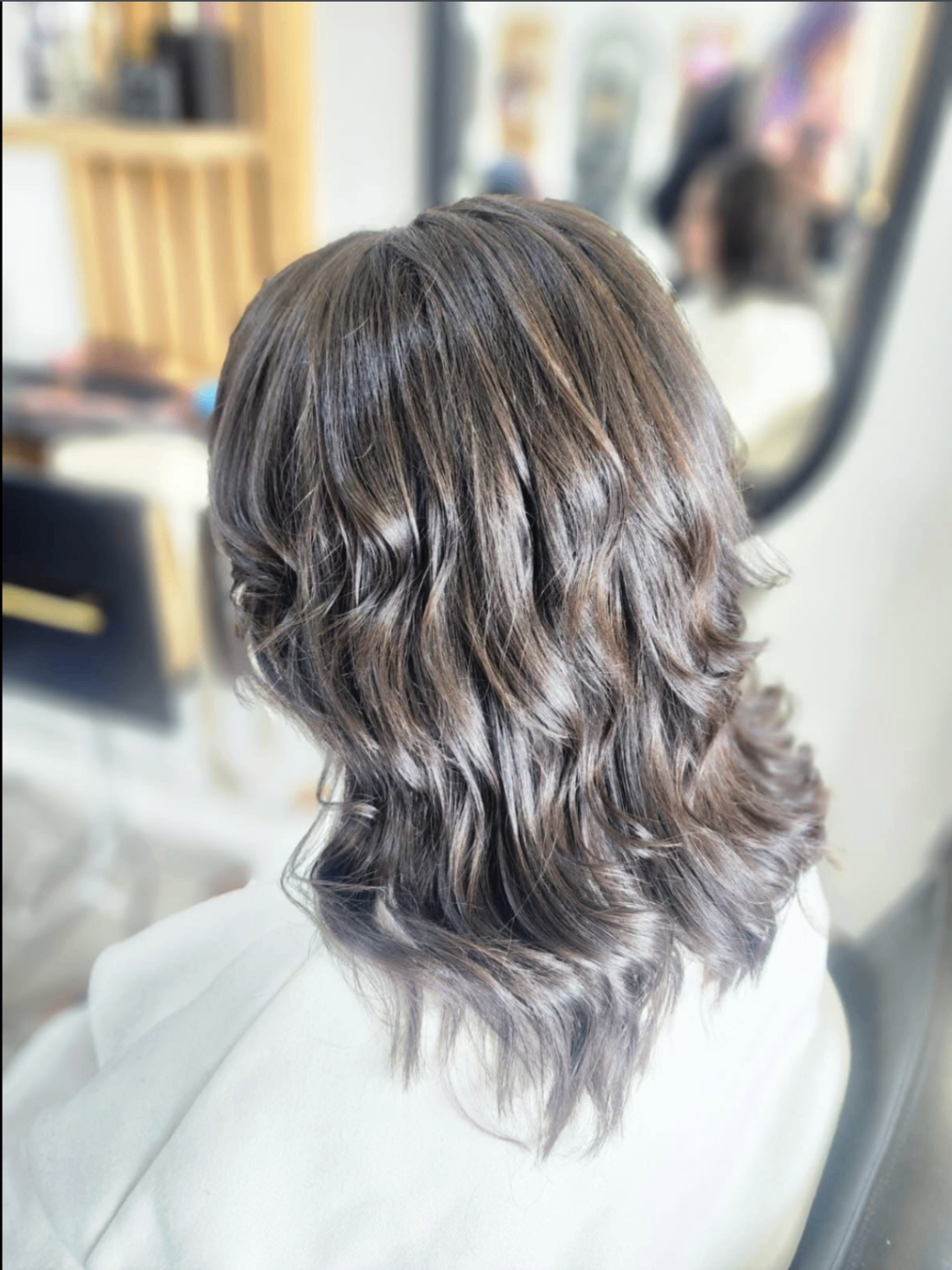 Glossy ashy silver-brown soft waves photographed inside Belle Vee studio
