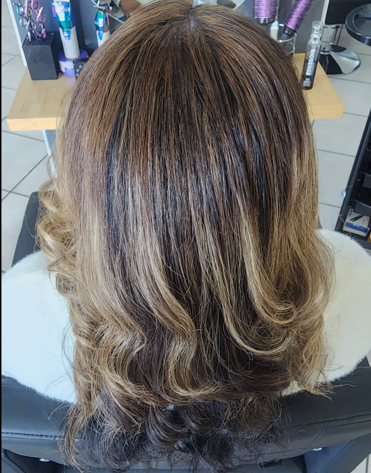 Rich dimensional brunette balayage with warm caramel and blonde tones at Belle Vee